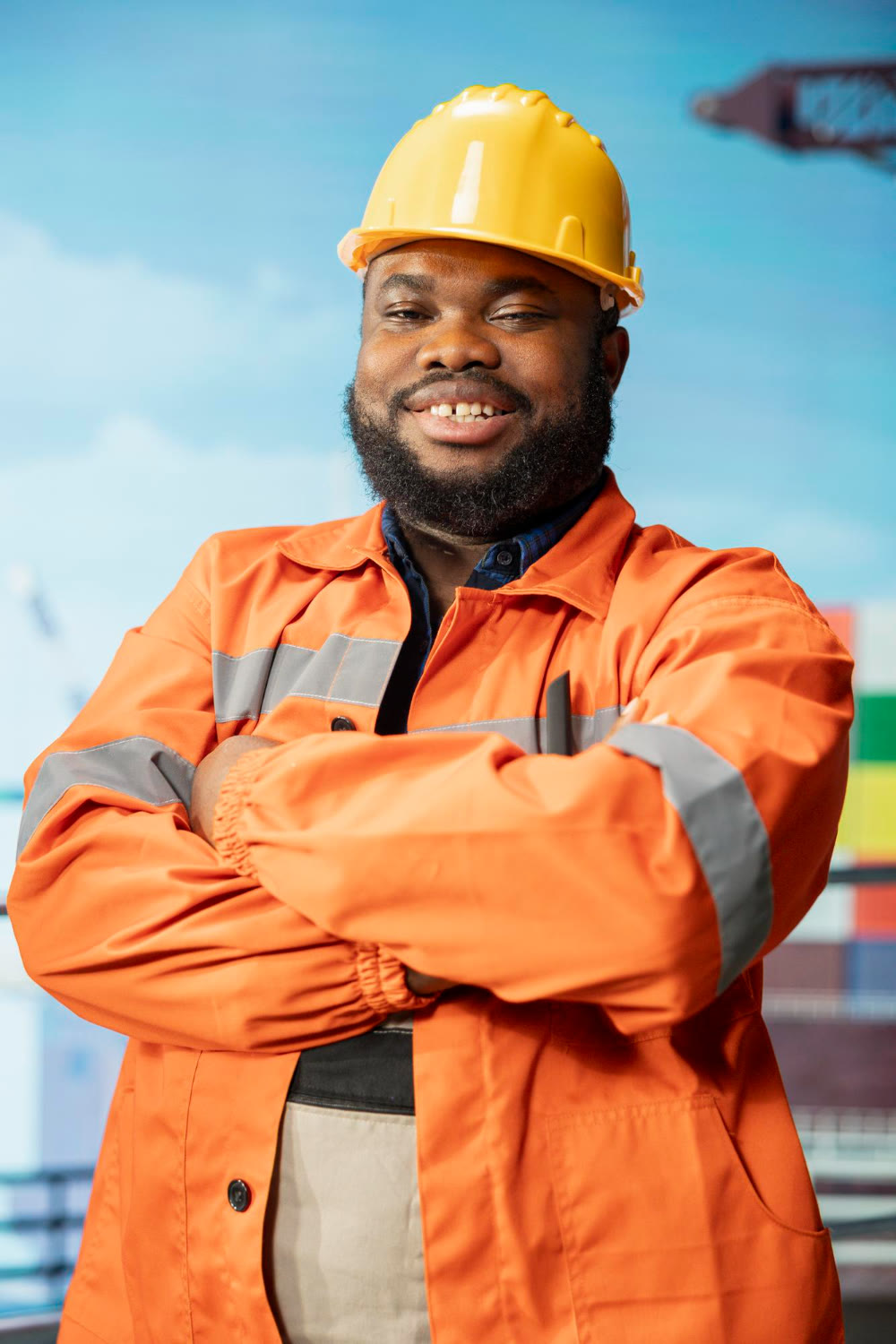 Confident offshore technician in a hard hat and hi-vis coverall