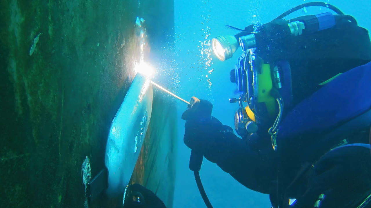 Commercial diver performing underwater welding on a subsea structure