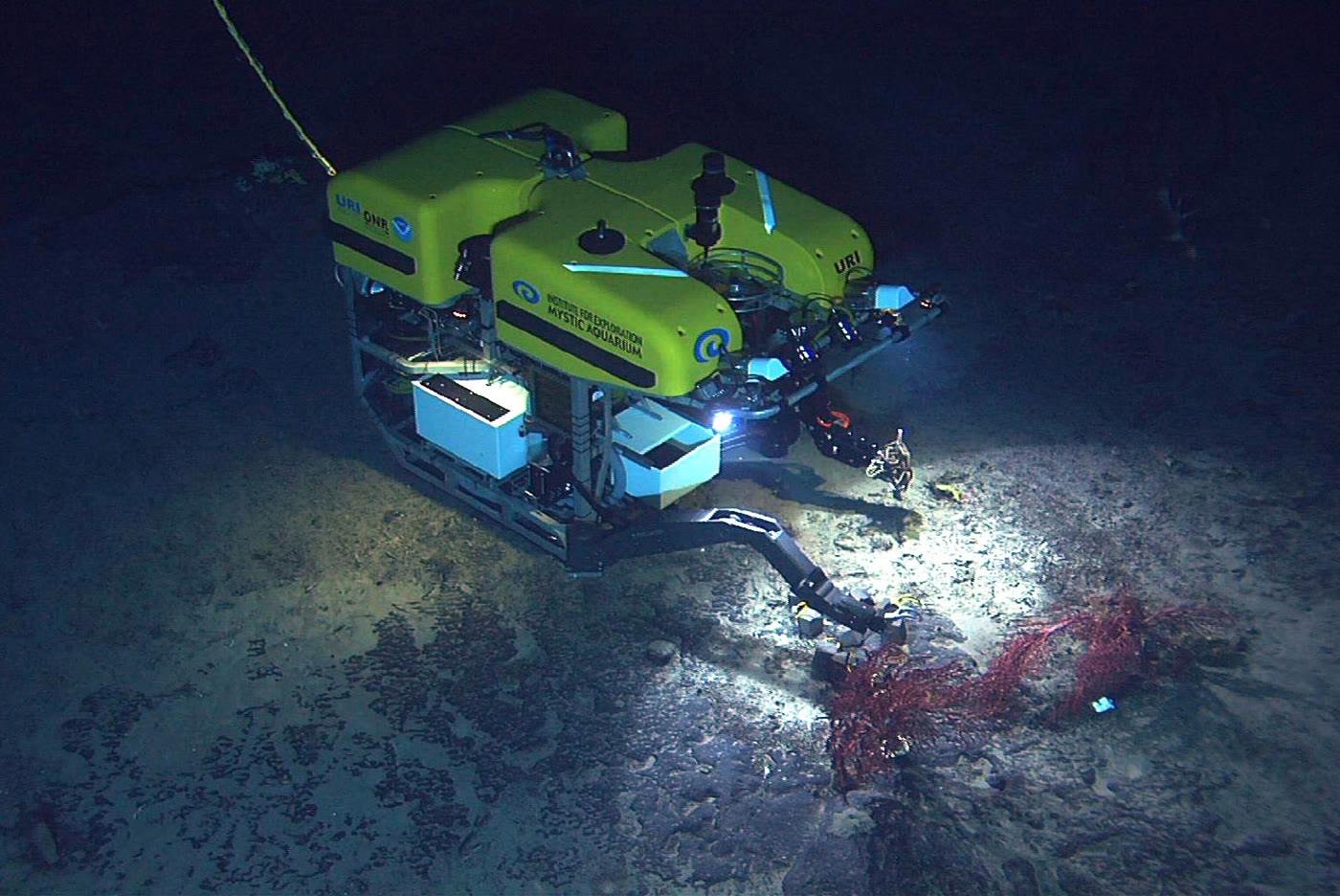 Work-class ROV manipulating debris on the seafloor using its robotic arm