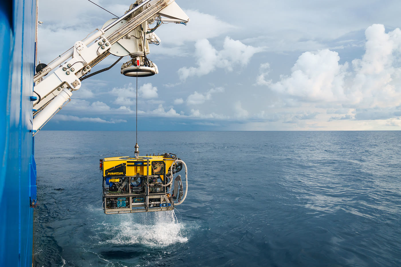 ROV being recovered from the sea by crane onto a support vessel